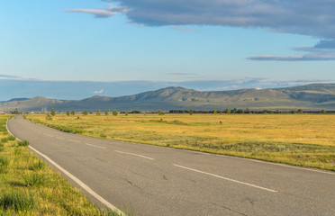 Sunny summer landscape, hills, forest, road, blue sky