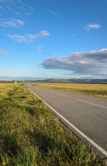 Sunny summer landscape, hills, forest, road, blue sky