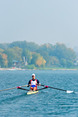 Male athlete rowing single scull