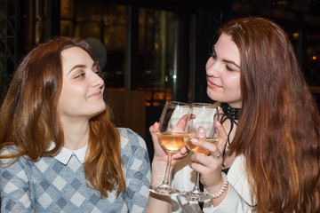 Two female friends drinking wine
