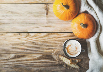 Pumpkins soup with cream and bread and pumokins with white cozy sweater