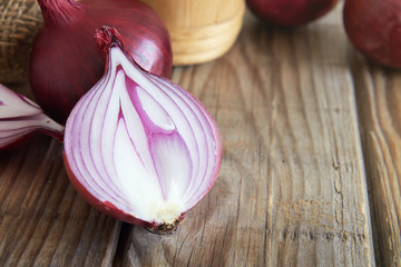 Red onion on rustic wooden background. Copy space