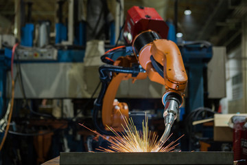Robot welding is welding metal part in factory