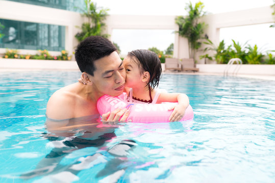 Vacation concept - happy family in a swimming pool