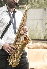 a man plays the saxophone