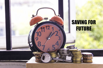 Clocks, keys, and coins with the word SAVING FOR FUTURE - the concept of savings