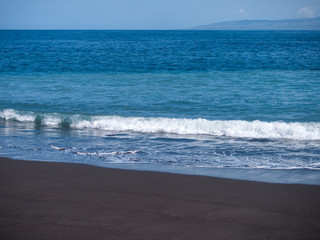 Black volcanic beach in eastern Bali Indonesia