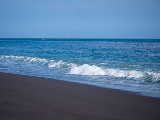 Black volcanic beach in eastern Bali Indonesia