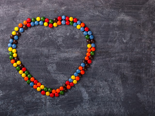 Background of Bright Colored Candy in the shape of a Heart.Holiday Valentine's Day.Holiday Valentine's Day.top view. Copy space. selective focus.