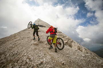 CORTINA D'AMPEZZO, ITALY - JULY 23 2017: bikers towards the Tofana di Rozes summit before descending it. Bikers are recording a video advertisement