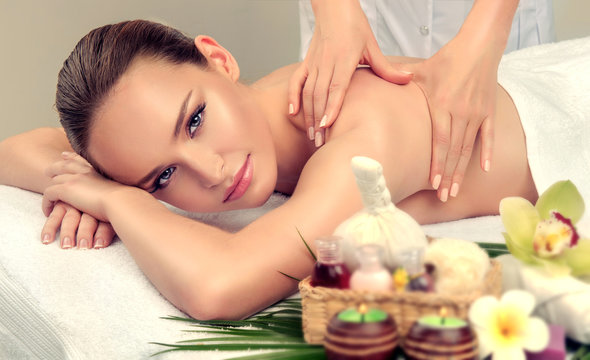 Massage and body care. Spa body massage treatment. Woman having massage in the spa salon for beautiful girl 