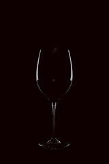 Mit Rotwein gefülltes Weinglas vor schwarzem Hintergrund