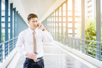 Professional businessman  using smartphone talking on his phone  outside