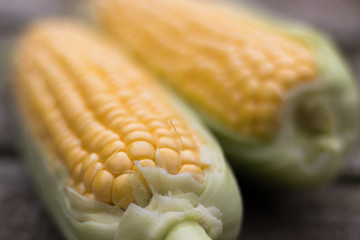 Yellow Sweet Corn cob on a patina wood surface