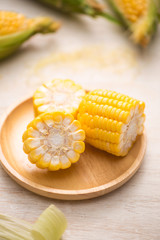 Sweet corns. Fresh corn on cobs on wooden table.