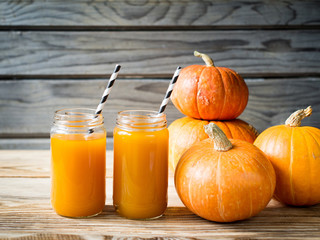 Pumpkins juice in bottle with pumpkins