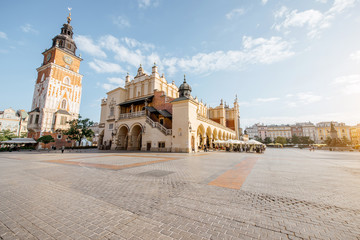 Fototapeta Cityscape view on the Market square with Cloth Hall building and town hall tower during the morning light in Krakow, Poland obraz