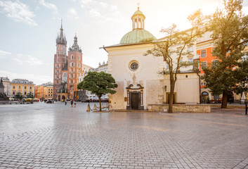 Fototapeta premium View on the Market square with saint Marys and Adalbert's church in Krakow during the morning light in Poland