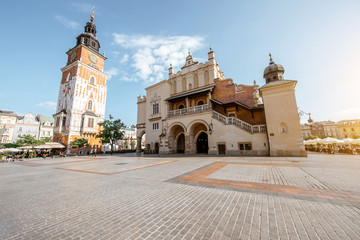 Fototapeta premium Cityscape view on the Market square with Cloth Hall building and town hall tower during the morning light in Krakow, Poland