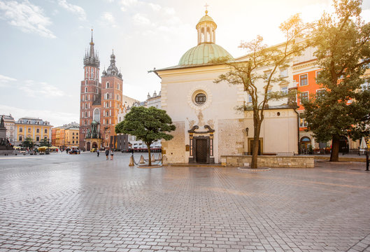 View on the Market square with saint Marys and Adalbert's church in Krakow during the morning light in Poland