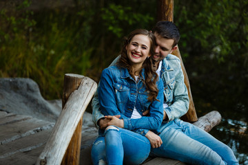 beautiful couple hugging each other near a mountain river