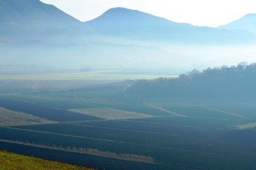 Hills in winter with fog