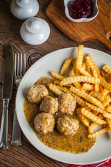 Meatballs with french fries in dill sauce.
