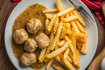 Meatballs with french fries in dill sauce.