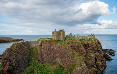 Fototapeta na wymiar A view of Dunnottar Castle from west side in cloudy spring weather, Scotland