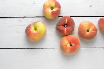 peaches on a white wooden table top view