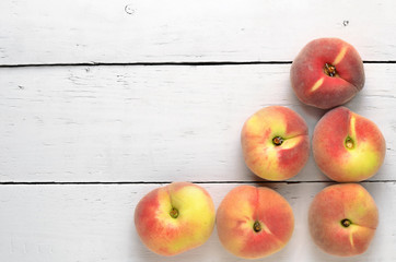 peaches on a white wooden table top view