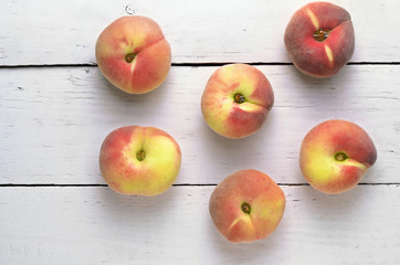 peaches on a white wooden table top view