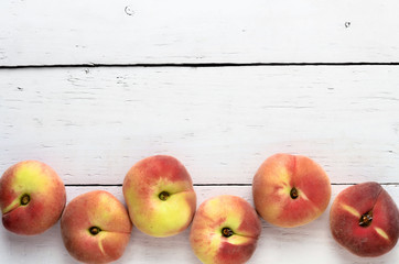 peaches on a white wooden table top view