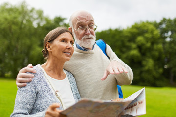 Senior man explaining his wife what they going to visit next