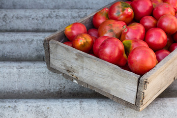 Tomatoes in a wooden box.