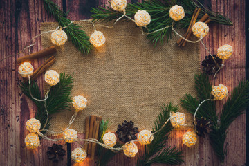 Christmas background pinecone with burlap and lights