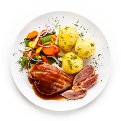 Grilled steak with vegetables on white background