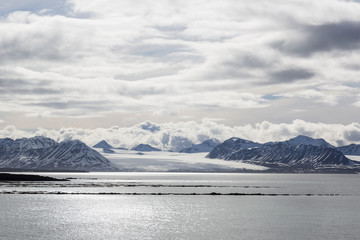 Fototapeta na wymiar Sea bay with mountains and glacier in Svalbard, Spitsbergen, Norway