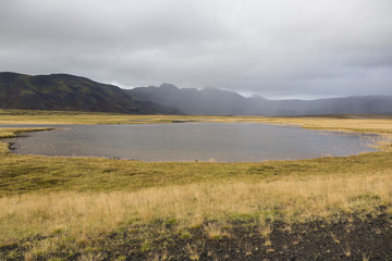 Fototapeta na wymiar Landscape in Iceland with a pond in the foreground during the autumn