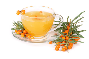 Sea buckthorn tea in a glass with berries isolated on a white background