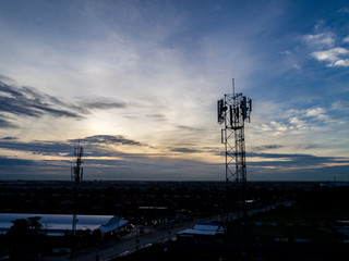 Fototapeta na wymiar Cell Phone Cellular tower antenna with blue sky in morning light