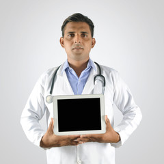 Doctor with stethoscope holding blank tablet pc
