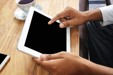 Hands touching blank tablet pc screen in the office