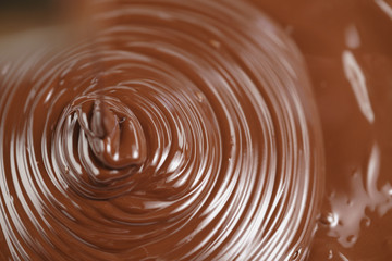 pouring melted premium dark chocolate from above