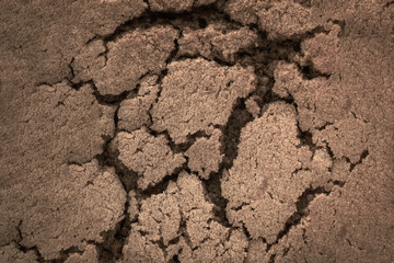 Crack in the ground, close-up of brown
