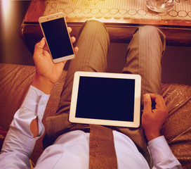 Man looking at blank tablet pc screen and blank mobile screen