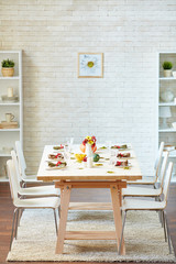 Empty room with served Thanksgiving table and six chairs for guests