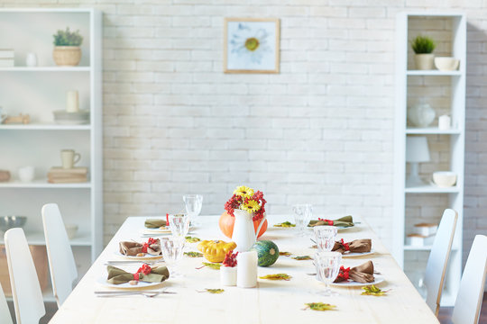 Festive table served for guests in dining-room of modern flat