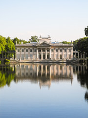 Fototapeta na wymiar Palac lazienkowski (Lazienski Palace) reflected on water in Warsaw, Poland