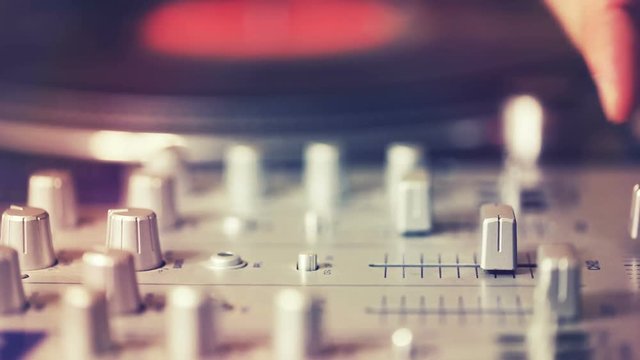 dj scratching and mixing music at party in club